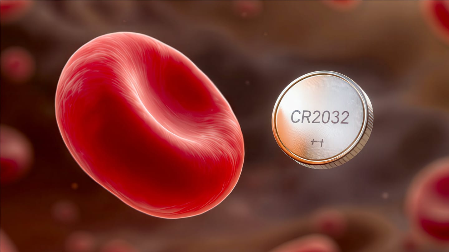A red blood cell floating next to a coin cell battery.