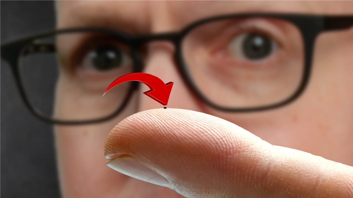 Matt Ferrell holding a microrobot on his finger