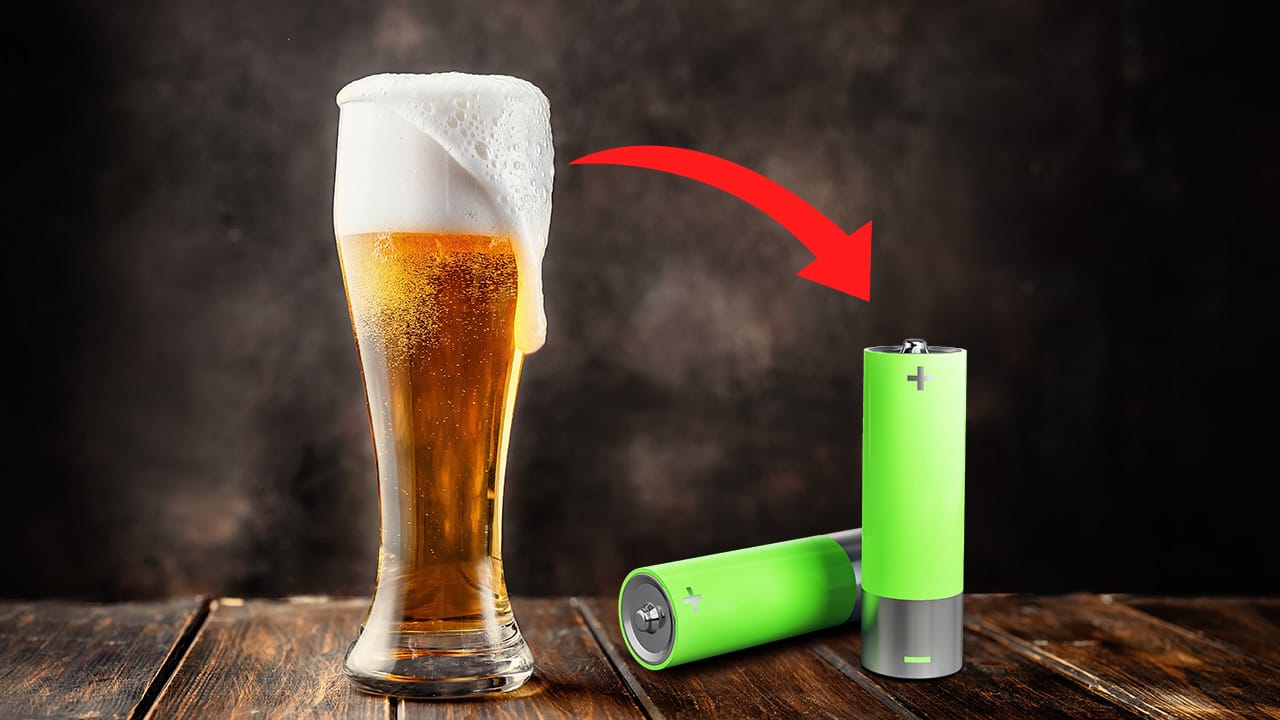 A beer filled glass, with an arrow pointing at some batteries