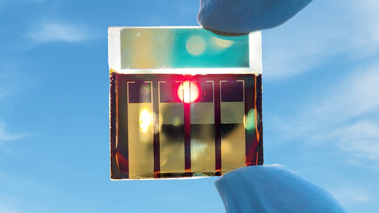 A perovskite solar cell held up to the sun