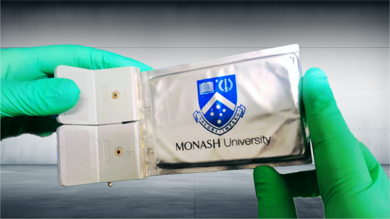 Gloved hands holding a Monash University Lithium Sulfur Battery