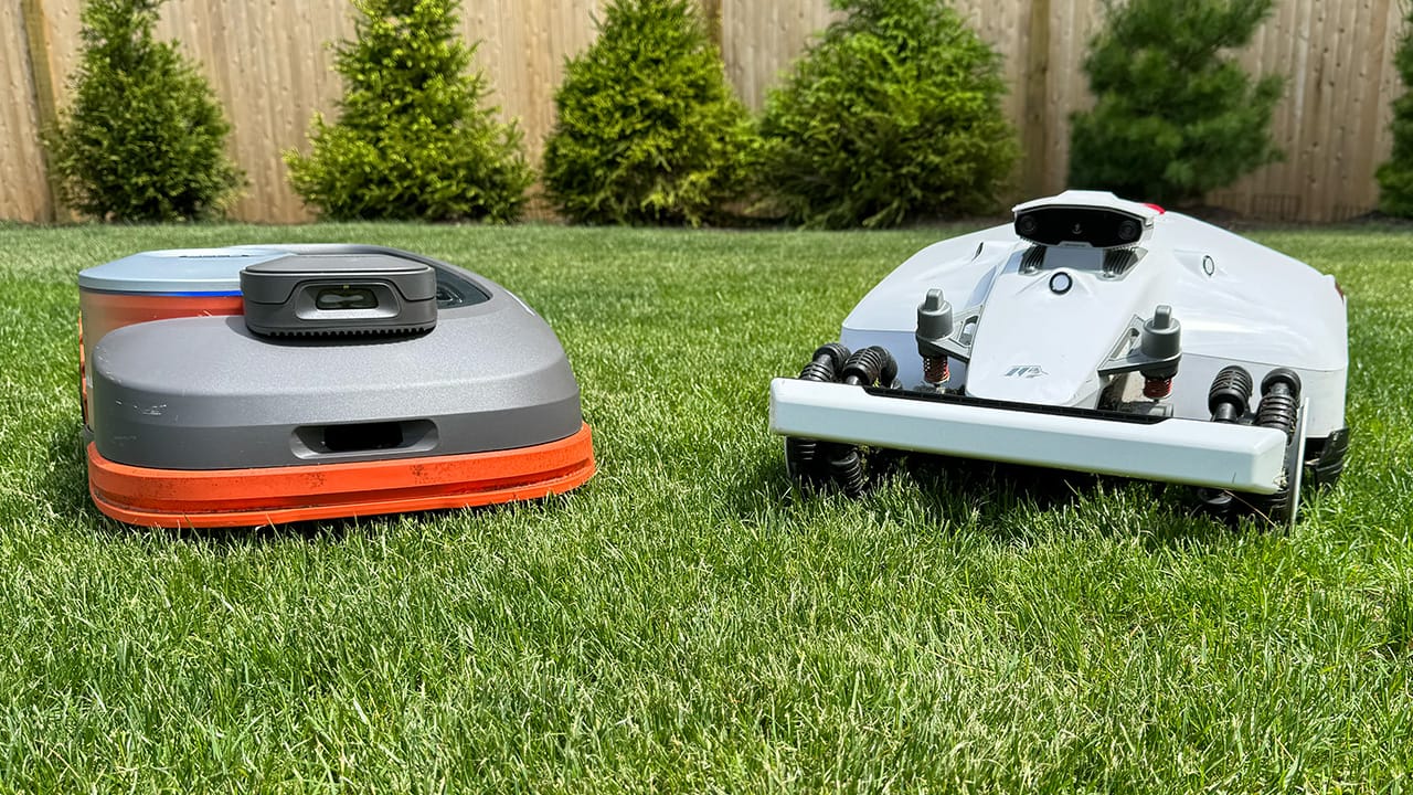 Two robot lawn mowers, the Segway Navimow H1500-VF and the Mammotion Luba 2 AWD 3000H next to each other on a lawn
