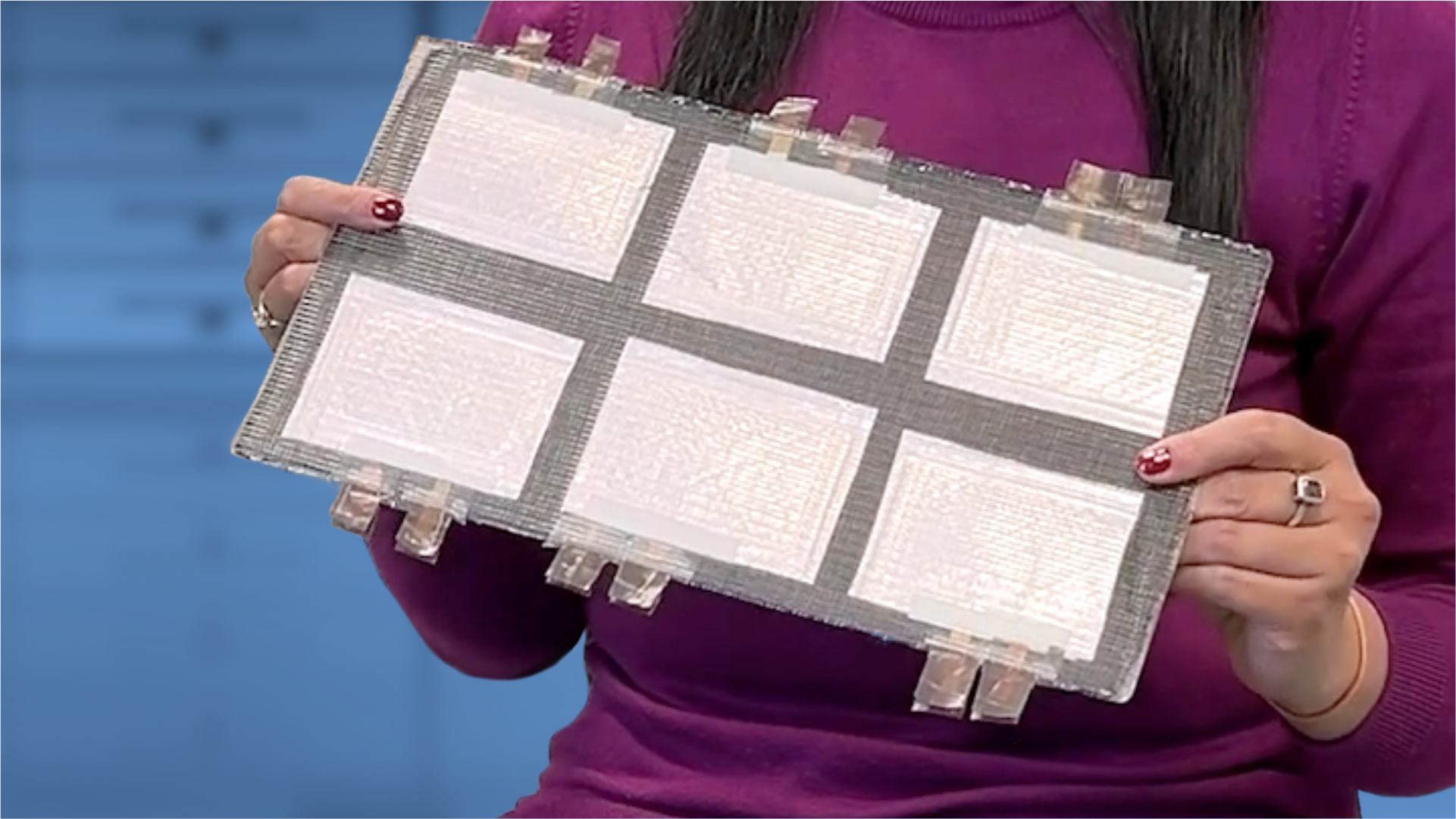 Someone holding up and showing a structural battery